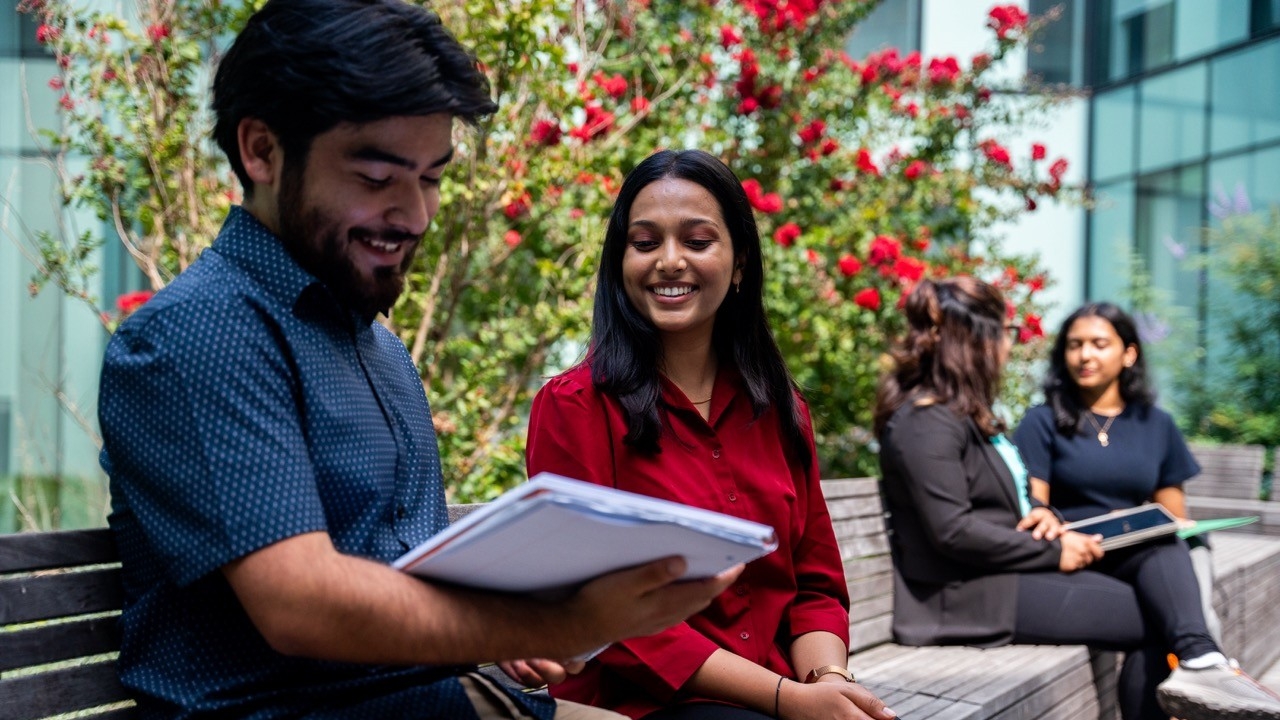 UC students talking in a classroom