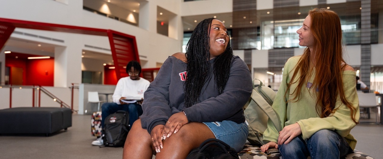 Students sitting in a university building talking