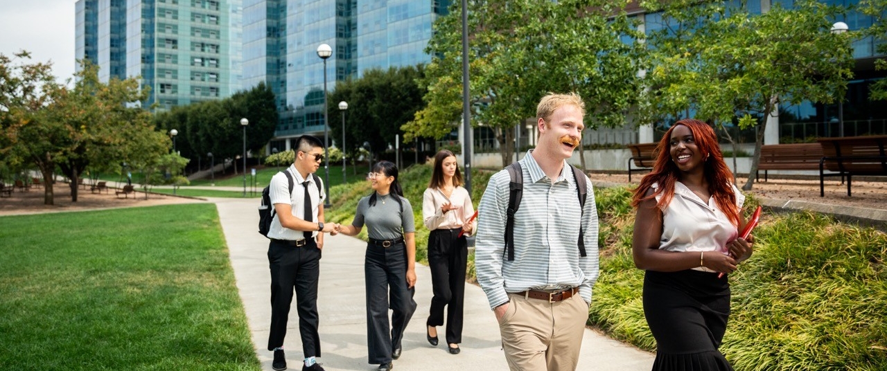 Students walking along a path on campus talking
