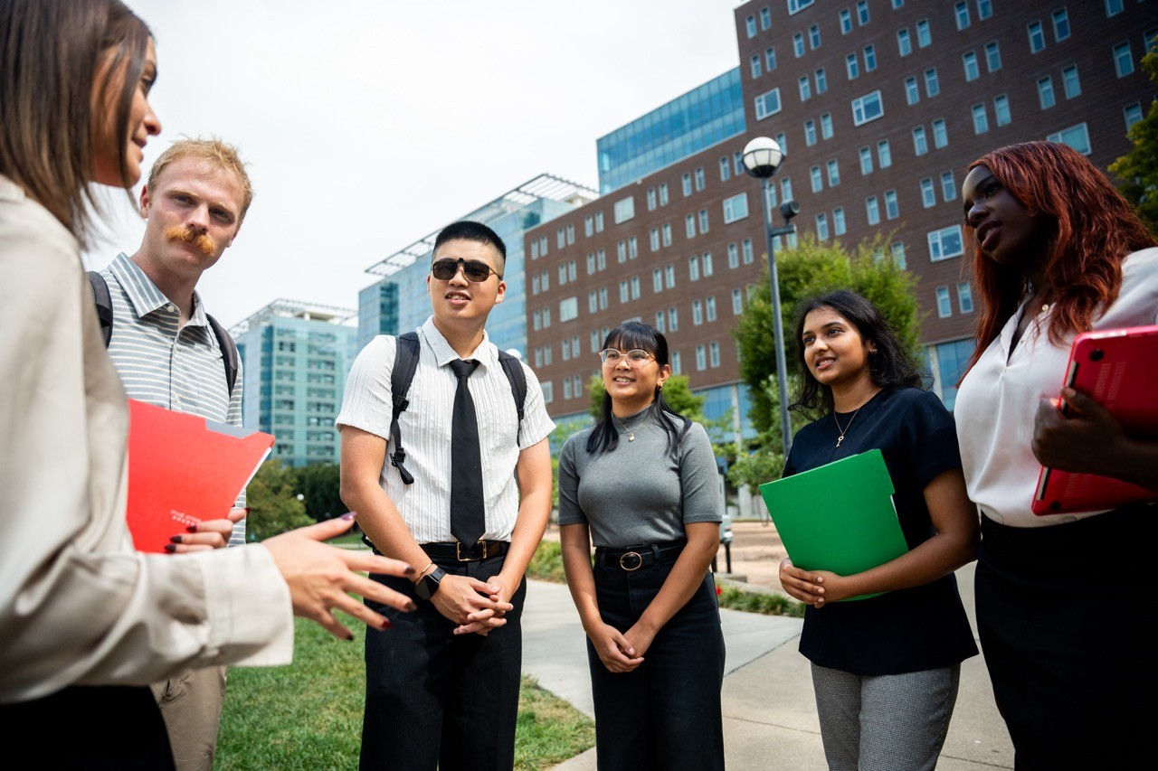 Students talking in a circle on campus