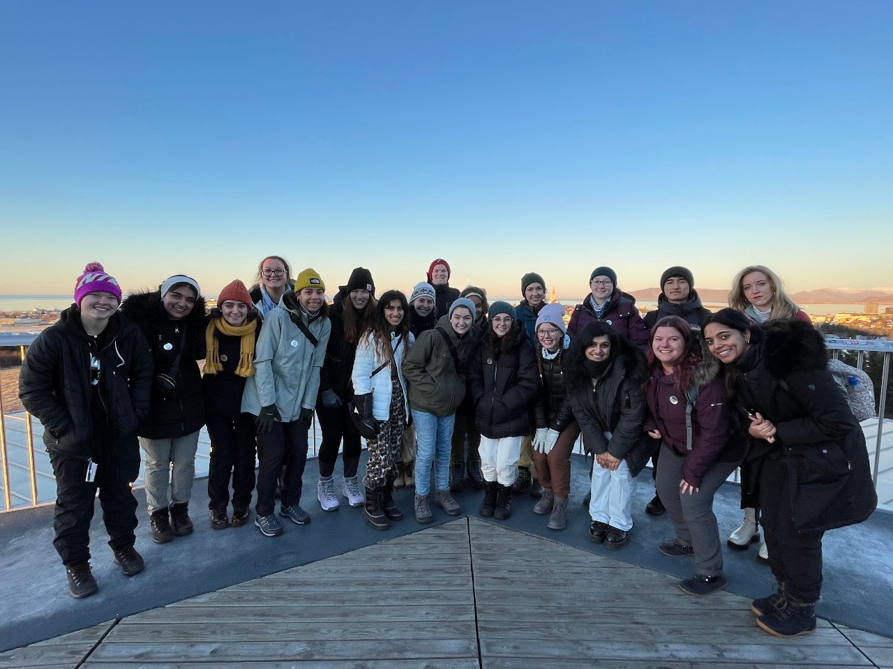 Students hiking on glacier in Iceland, wearing helmets and carrying ice picks