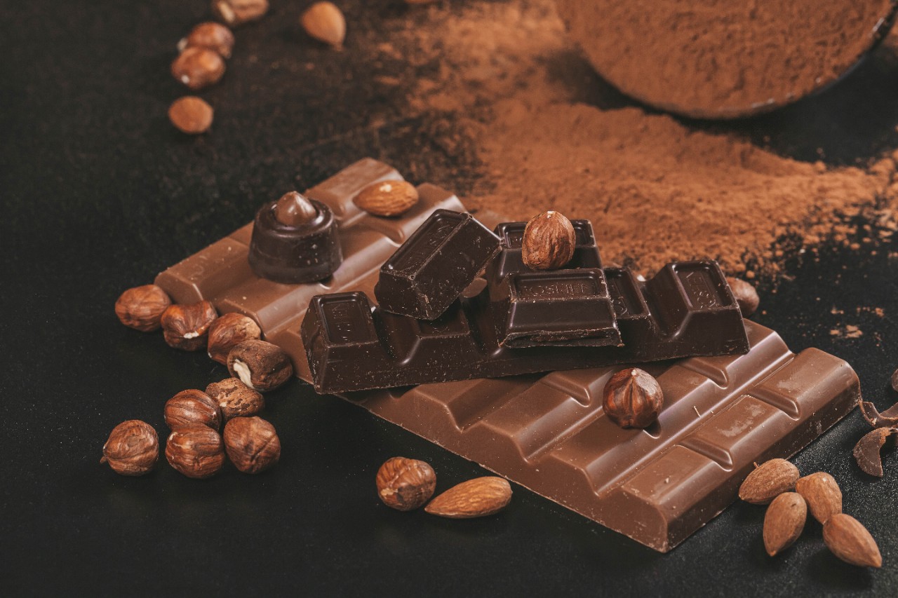 Bitter chocolate and milk chocolate with nuts, dark background