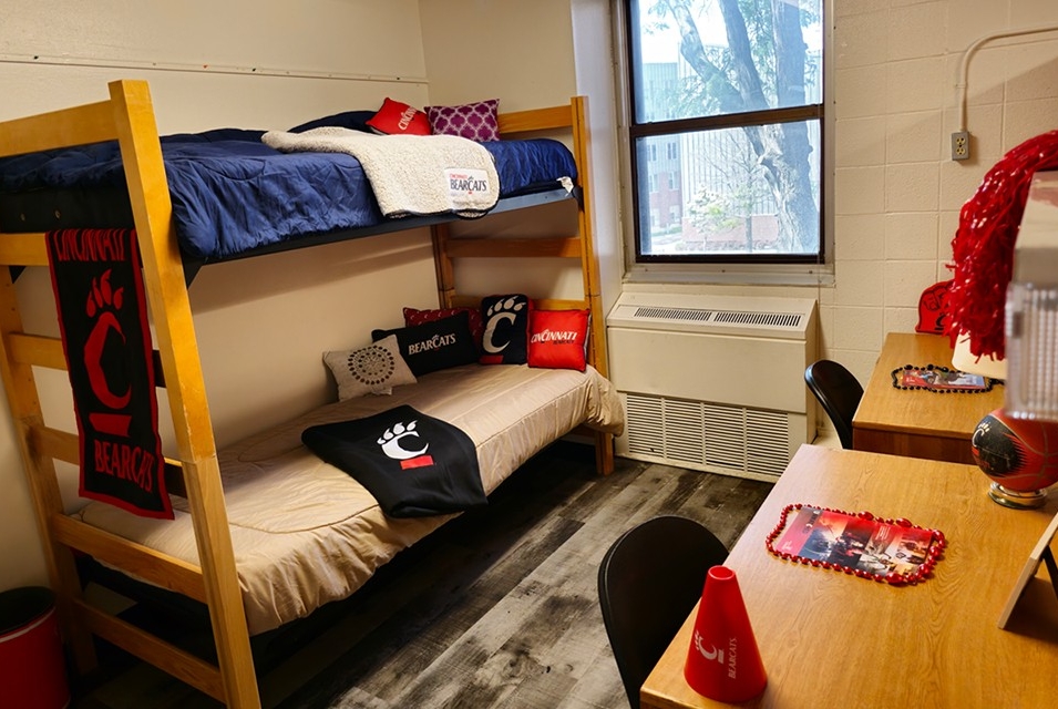sample of a traditional room showing a bunked bed window and desks. 