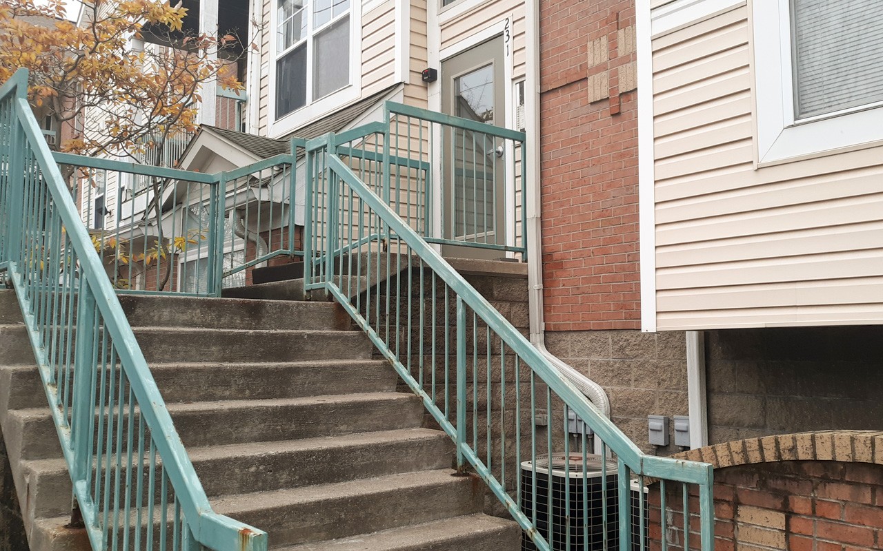 Staircase leading to apartment door at Bellevue Gardens.