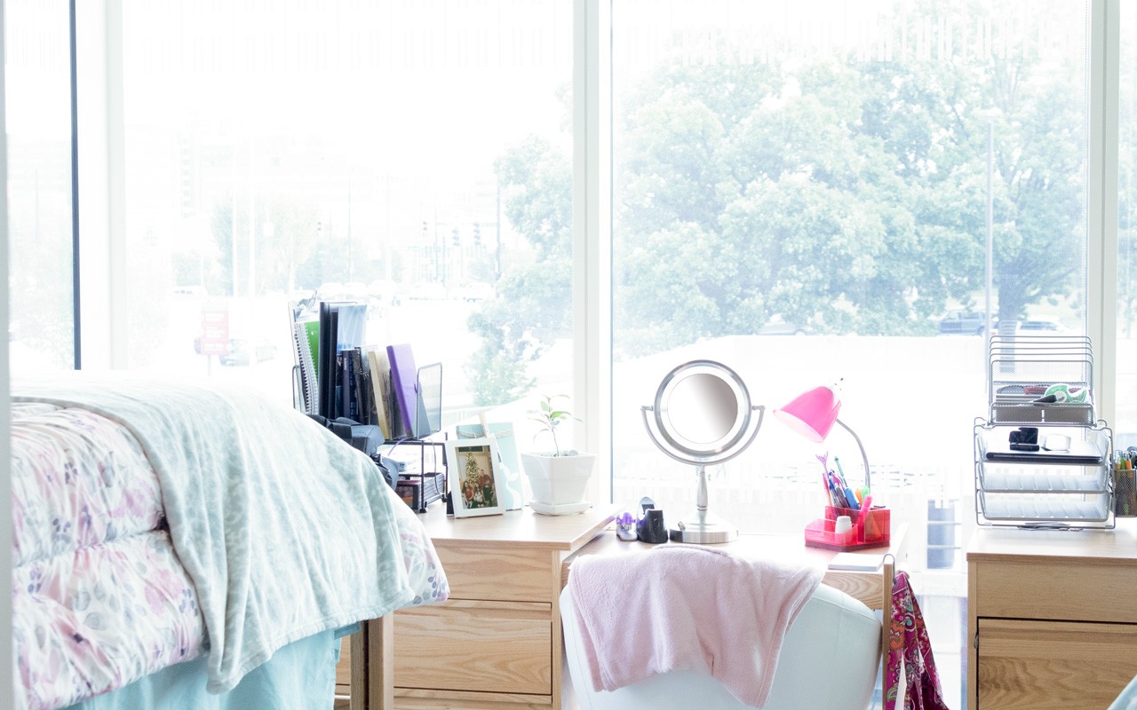 Loft bed, window, desk, and dresser in Morgens Hall room
