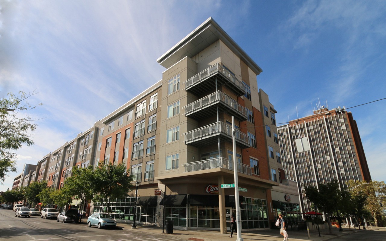 Exterior of U Square Apartments with the street in view. Balconies on the corner of the building are visible.