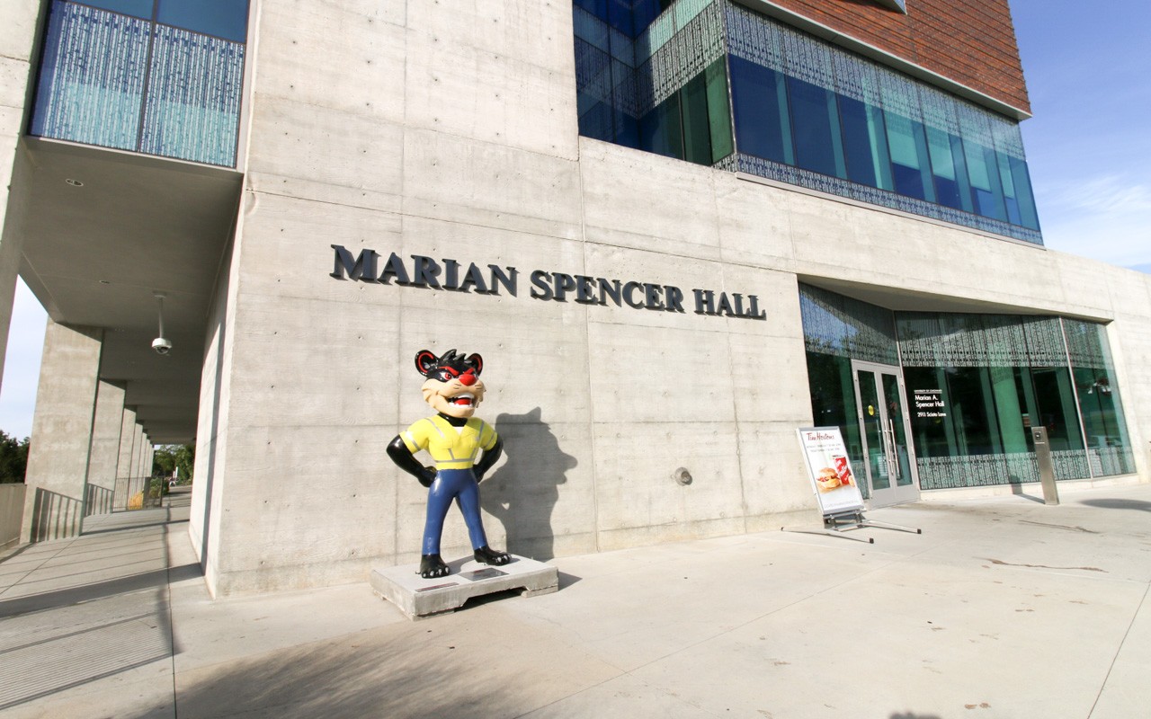 Entryway of Marian Spencer Hall. There is a Bearcat statue next to the entryway.