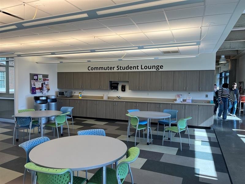 Commuter Student Lounge with round tables, chairs, and kitchen