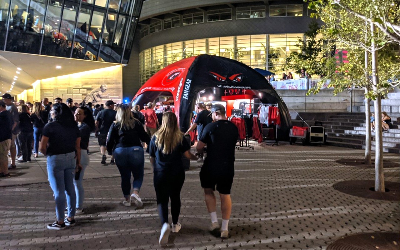 Red and black tent shop and Bearcats fans on the concourse of Nippert Stadium, near Tangeman University Center