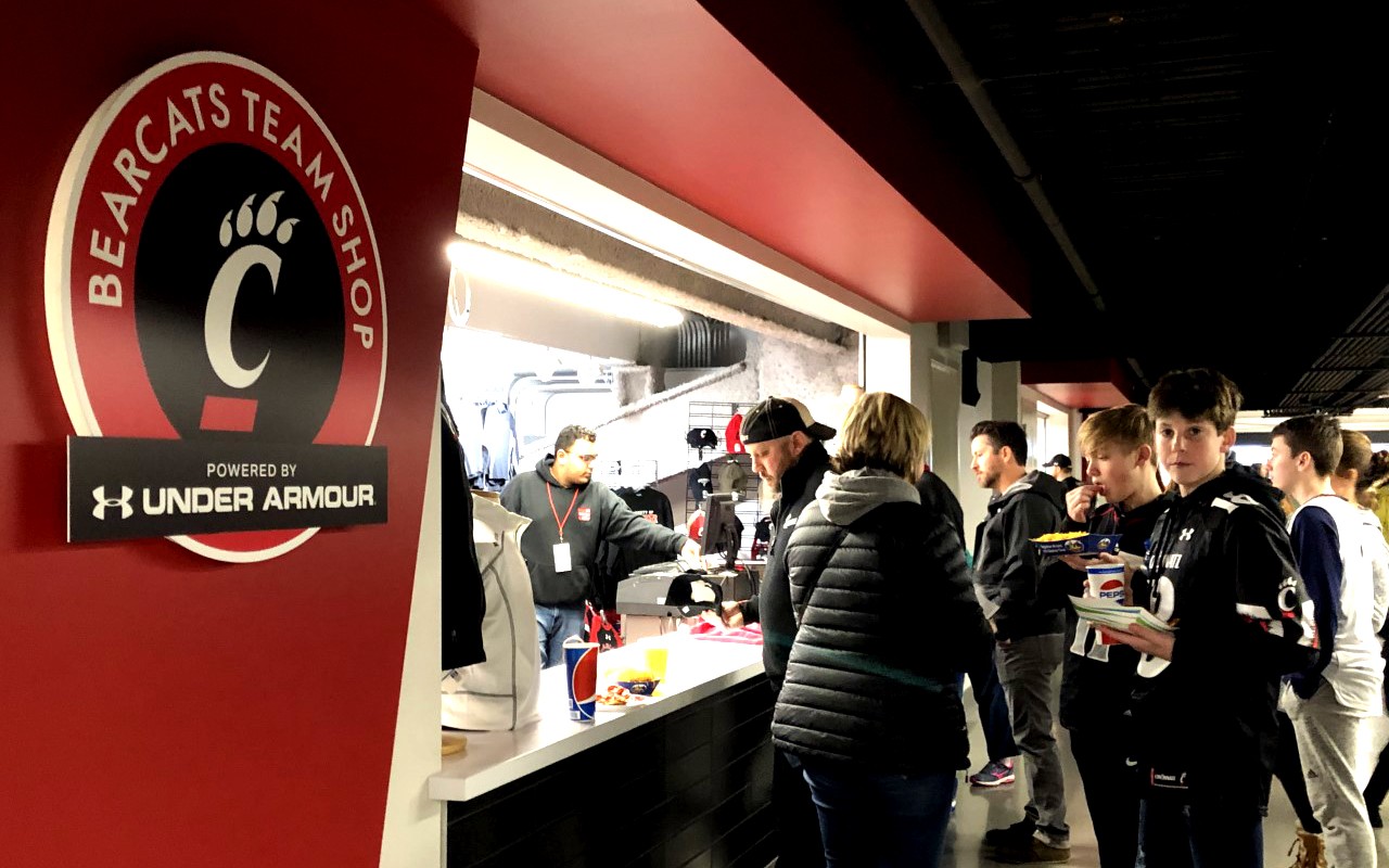 Shoppers at counter of Bearcats Team Shop in Fifth Third Arena.
