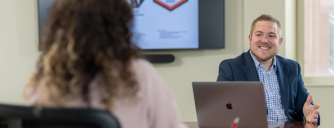 man and woman sit while talking