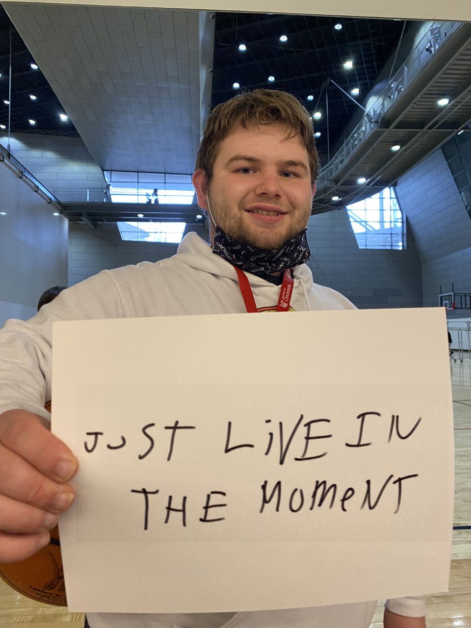 student holding sign of encouragement
