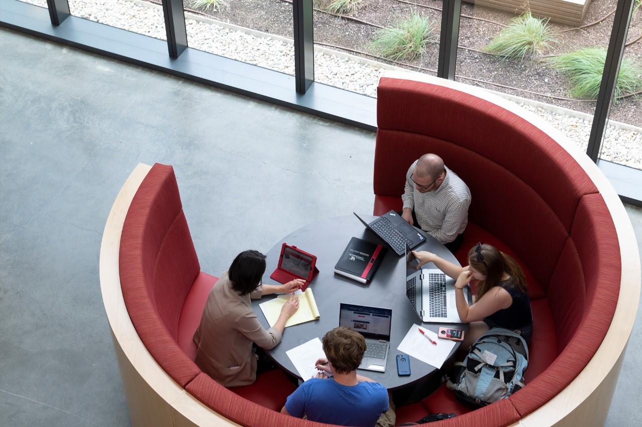 Students working in a seating area inside the new Lindner College of Business Building