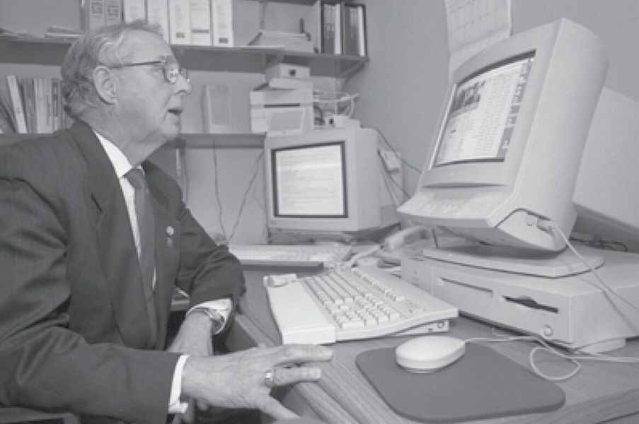 Black and white photo of a man on a computer