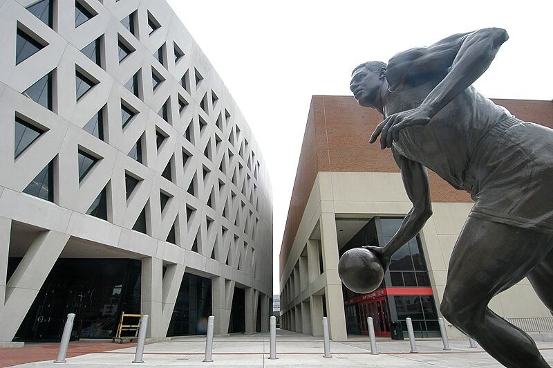 Oscar Robinson statue in front of campus buildings