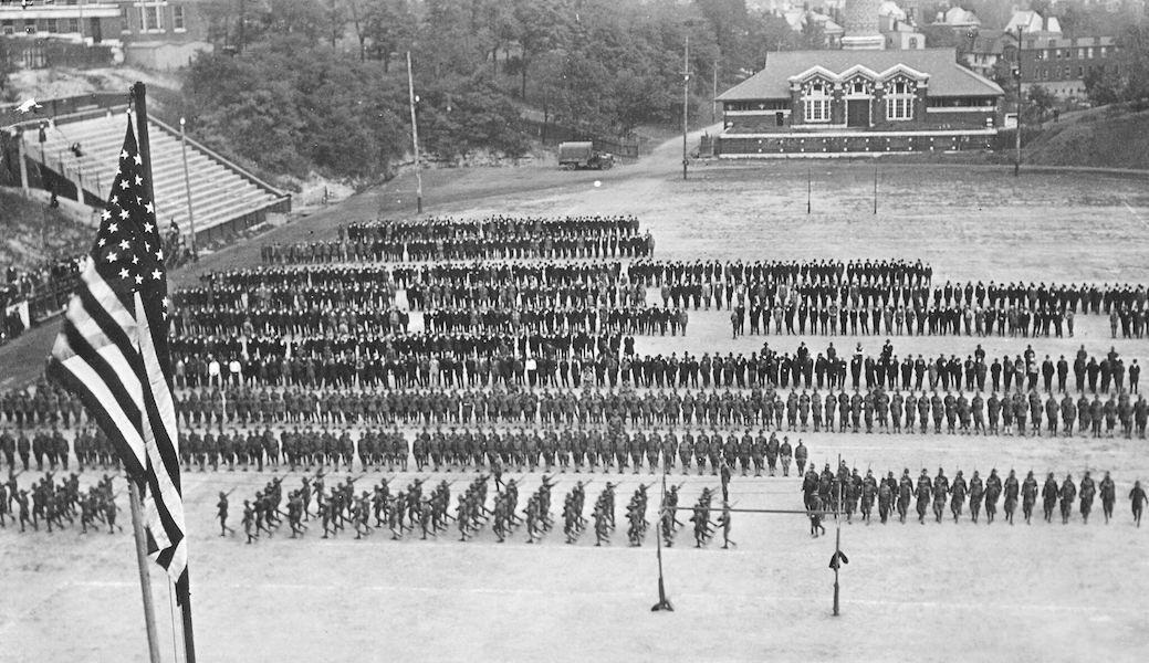 Black and white photo of soldiers lined up on a field