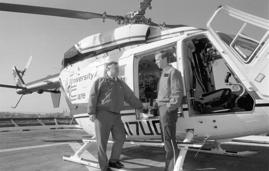 Black and white photo of UC air care helicopter