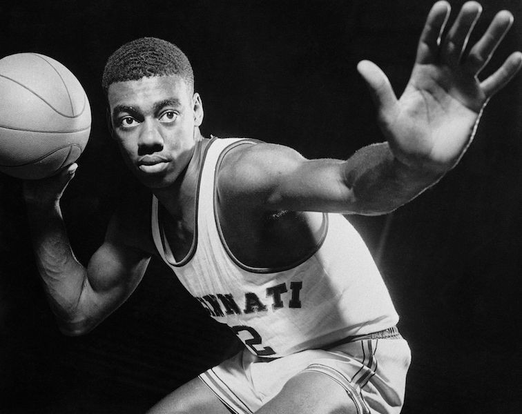 Black and white photo of Oscar Robinson posing with basketball