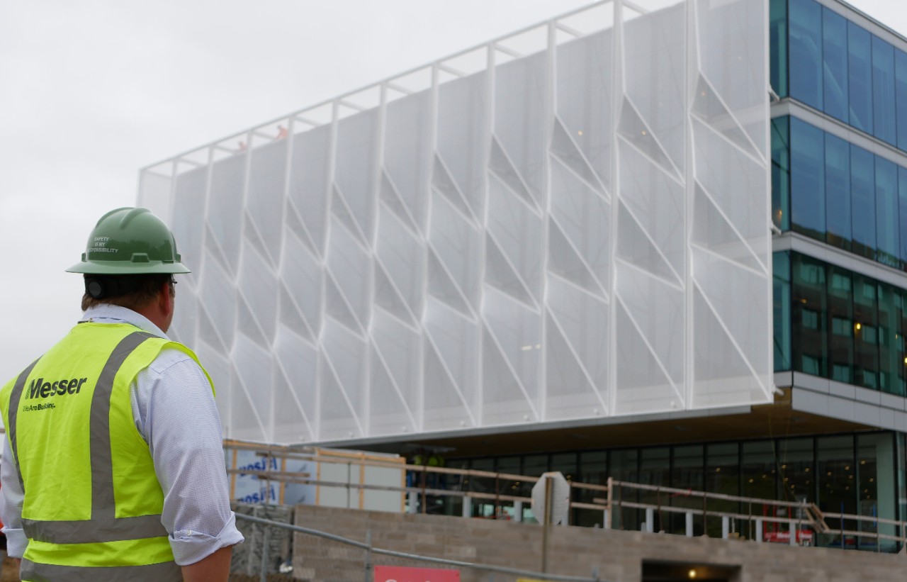 Mealy looks on at building.