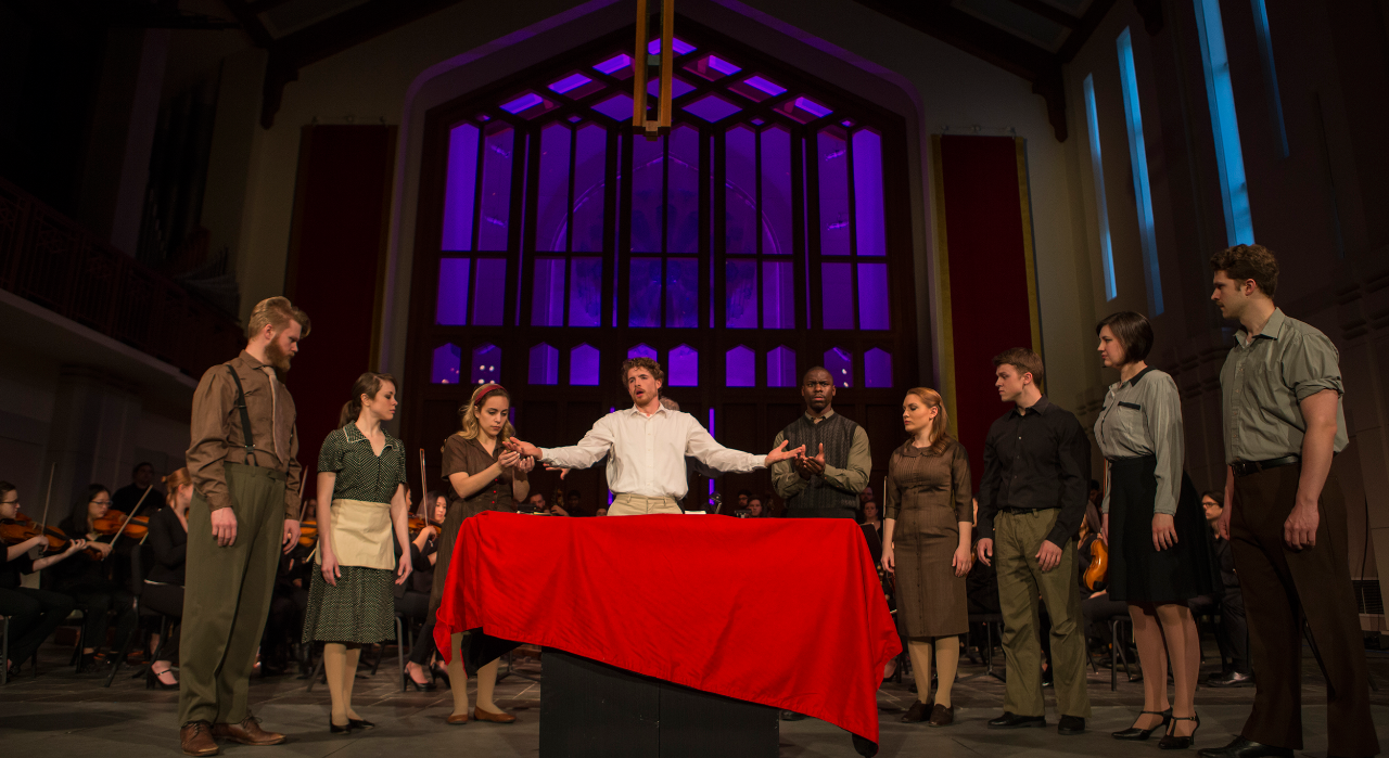 Students  lined up singing on stage in a choral concert