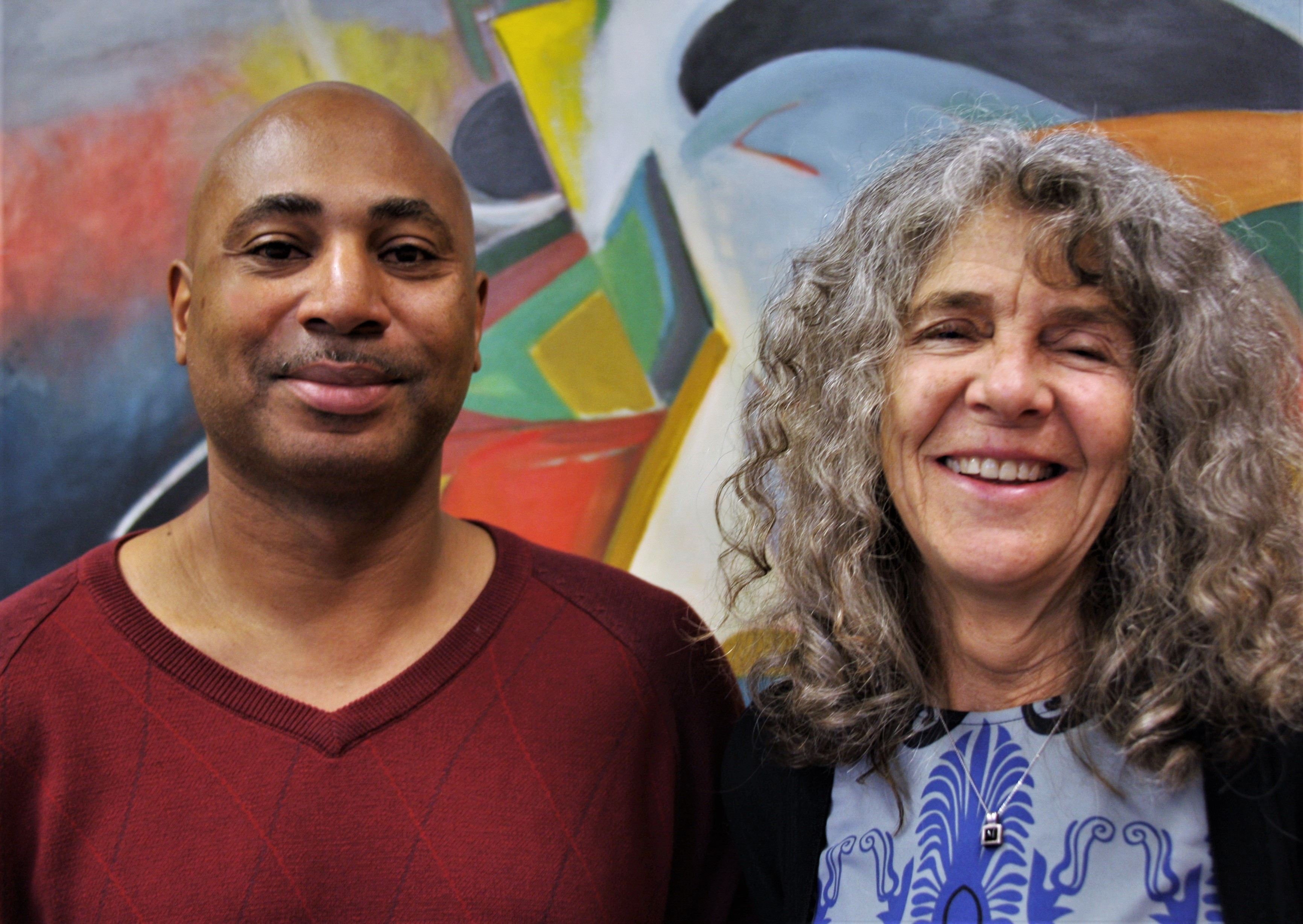 Head shot of Wright and Linders in front of an abstract painting