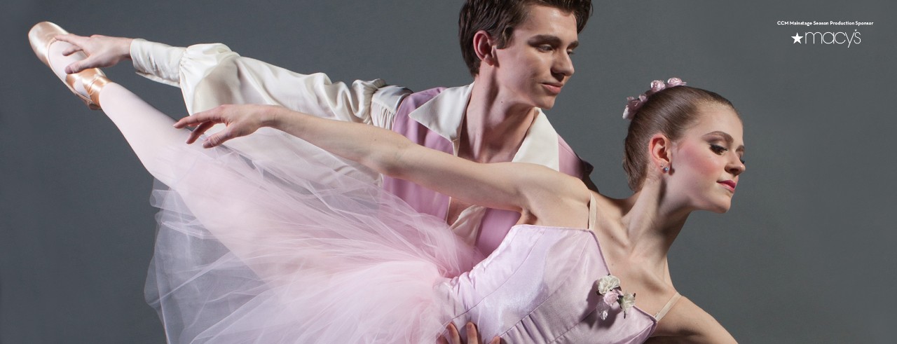Man and woman dancing in traditional ballet costumes.
