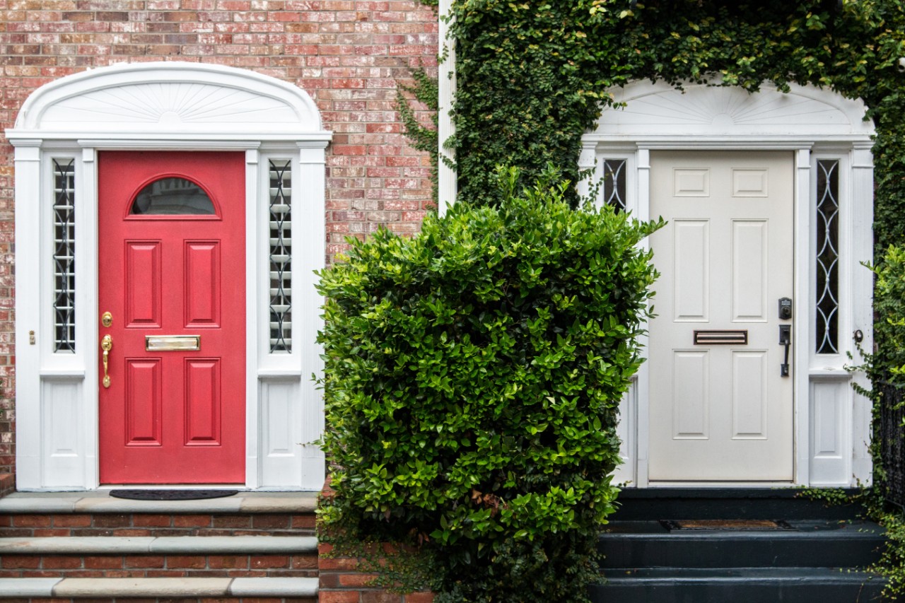two doors on the side of a building on a city block