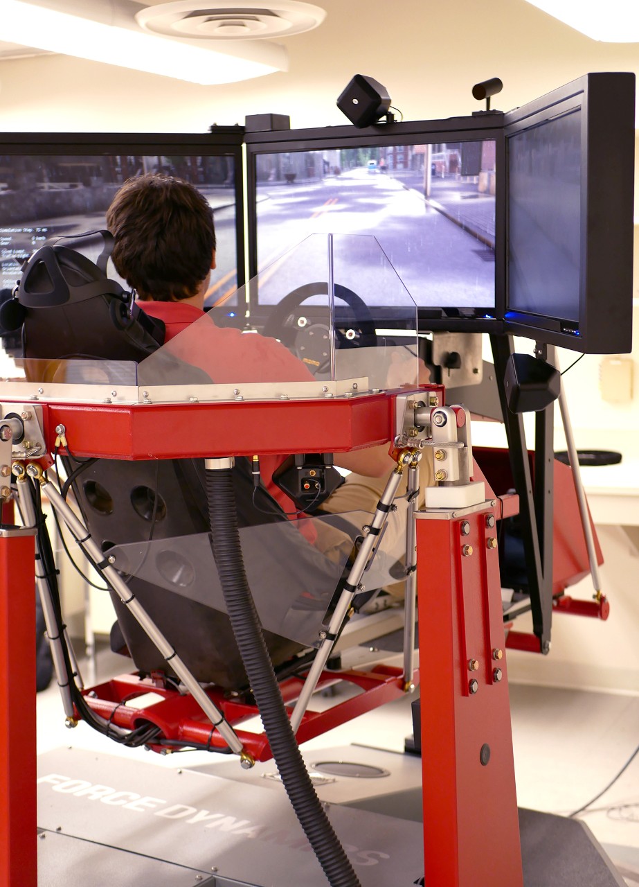 student sitting in driver simulator