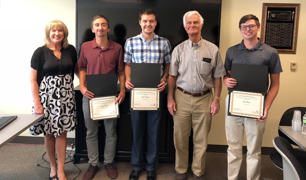 scholarship recipients pose with Frank Tepe and Janet Ransom with scholarships.
