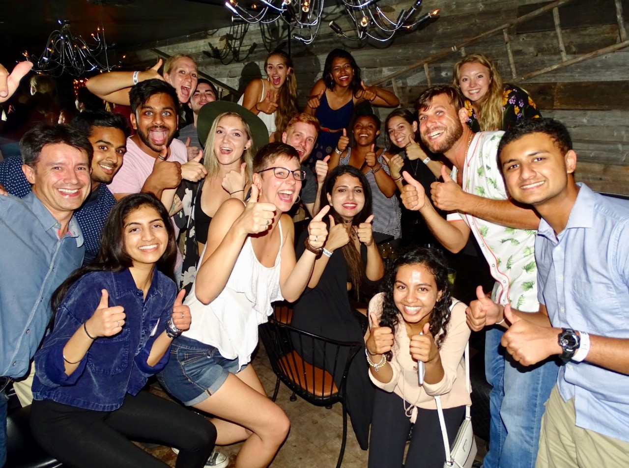 Students from UC and Montreal give the thumbs up in a Canadian cafe.