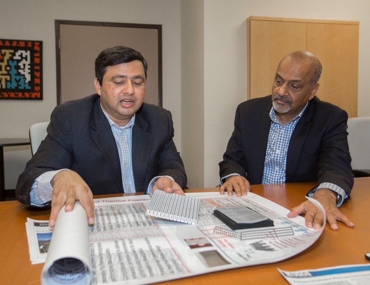 Dr. Milind Jog, PhD, left and Dr. Raj Manglik, PhD UC engineering research partners discussed their ongoing work at Rhodes Halls. UC/Joseph Fuqua II 