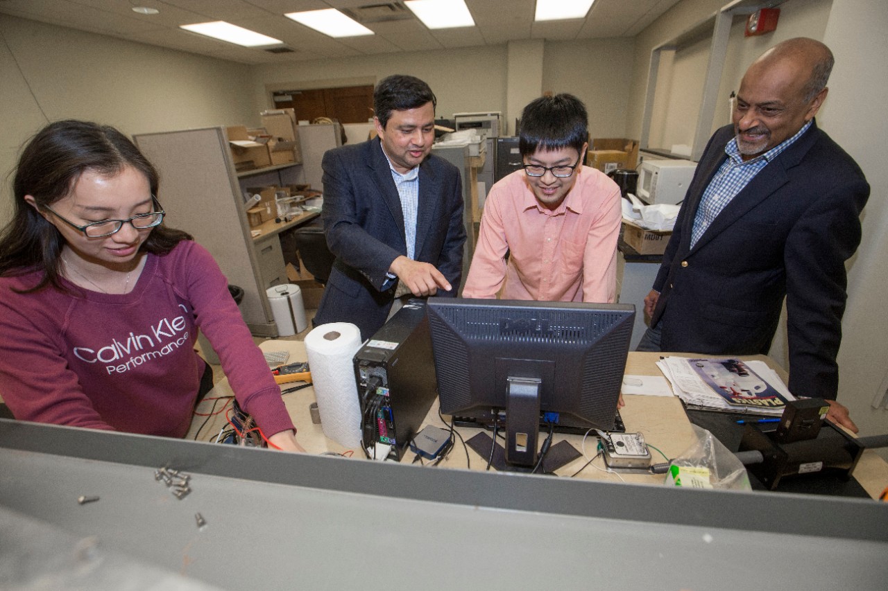 Dr. Milind Jog, PhD, left and Dr. Raj Manglik, PhD UC engineering research partners discussed their ongoing work at Rhodes Halls. UC/Joseph Fuqua II 