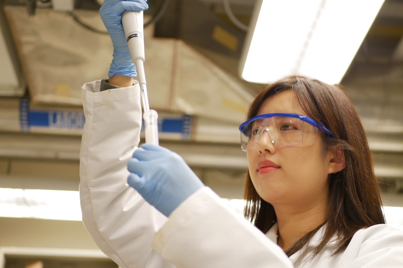 Cao inspects water in test tube
