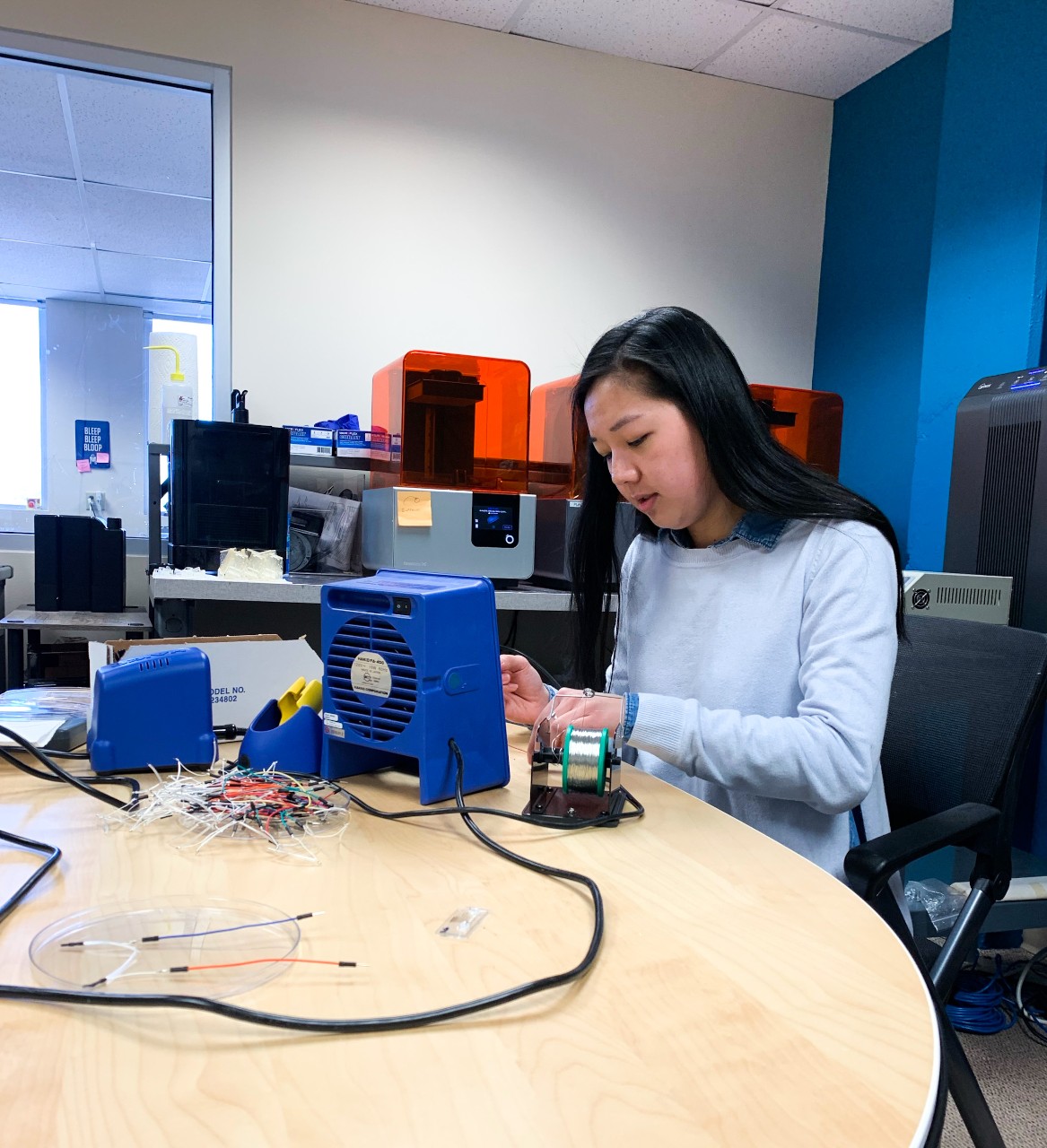 Tilley works on equipment on table