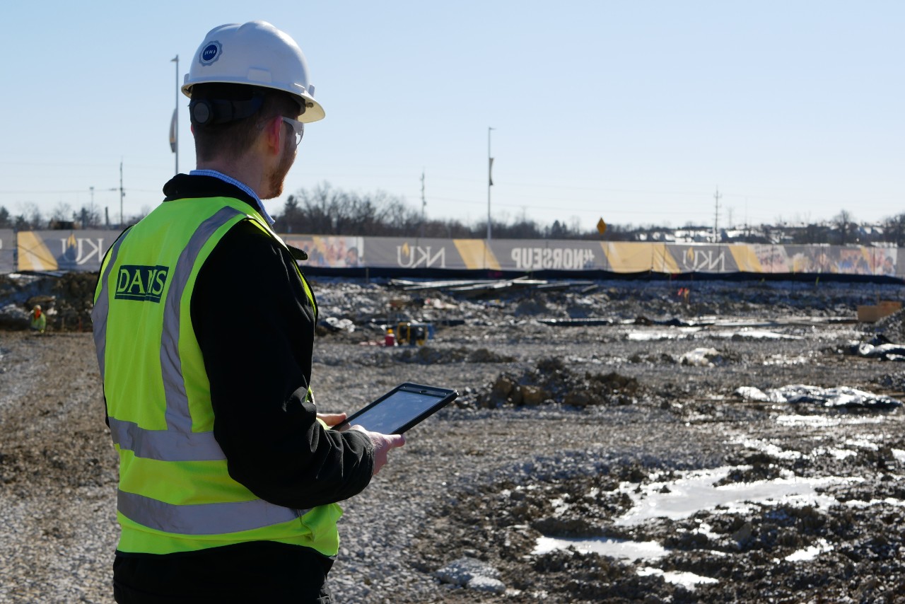 Zack Greene poses outside on a construction site