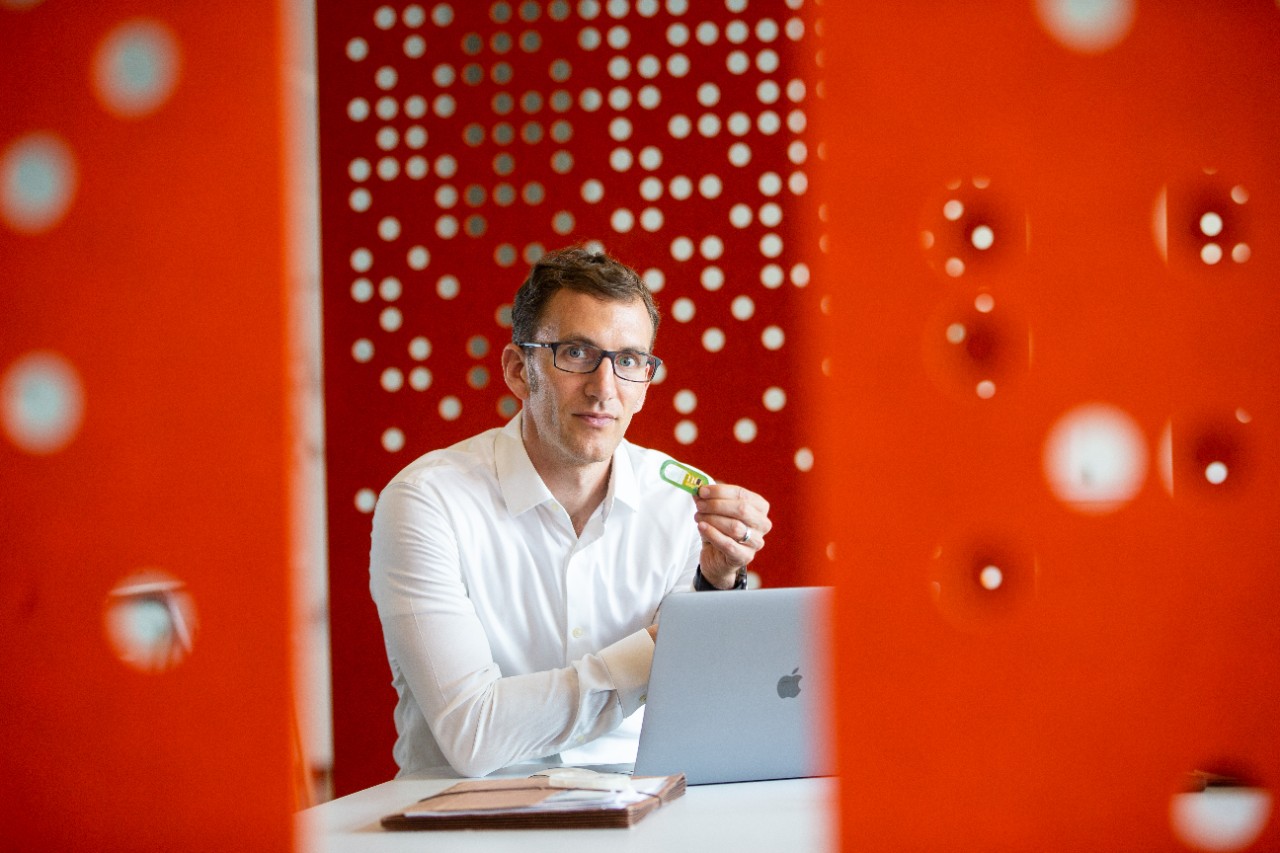 UC professor Jason Heikenfeld holds up a sweat sensor at the 1819 Innovation Hub.