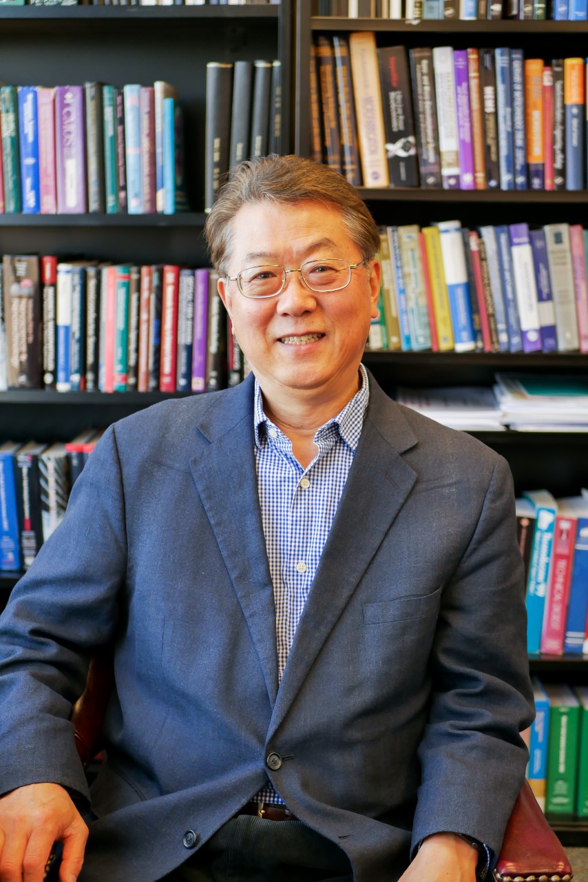 Ahn sits in front of books in office