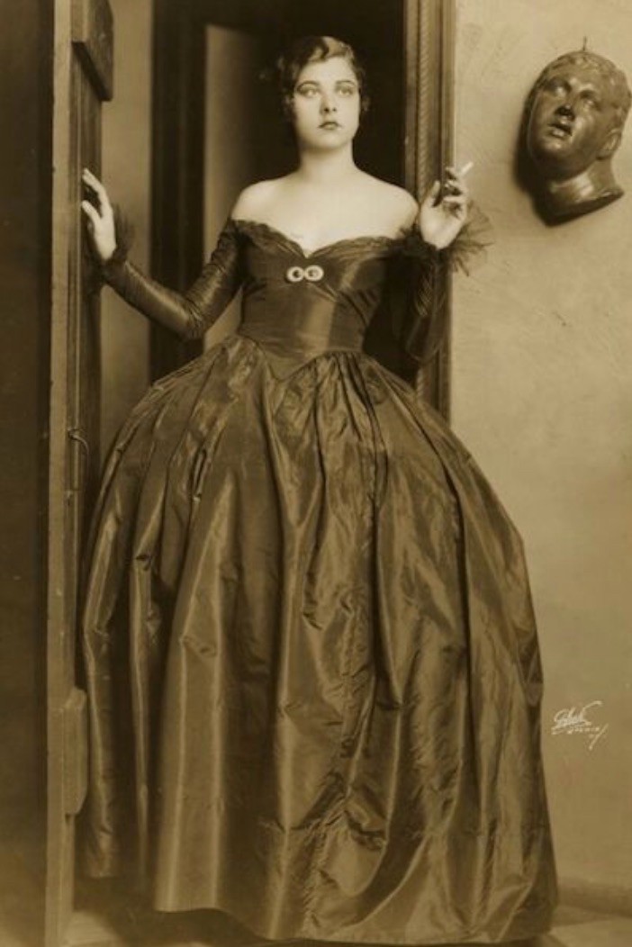 Libby Holman, 1923 UC grad dressed in formal gown holding a cigarette