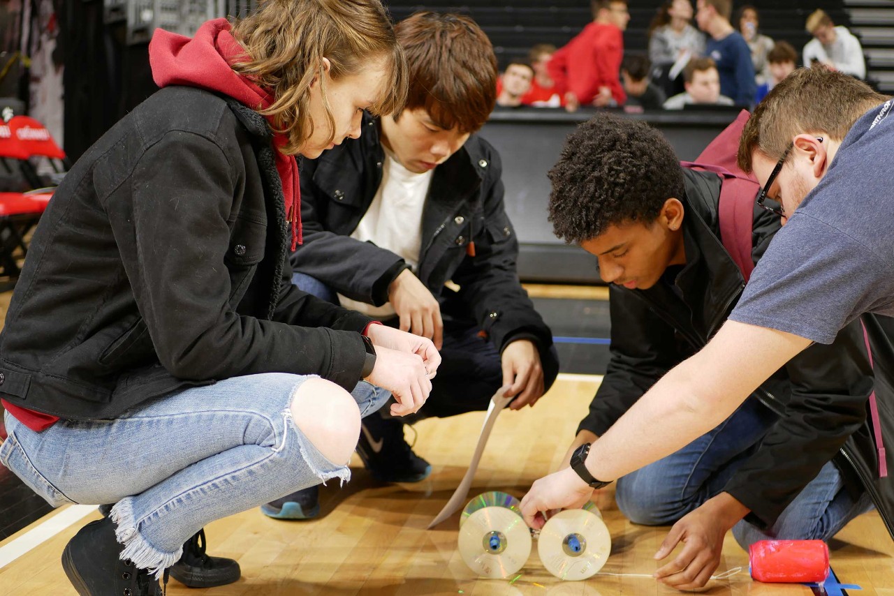 Students at the event work together to test their mousetrap tractors