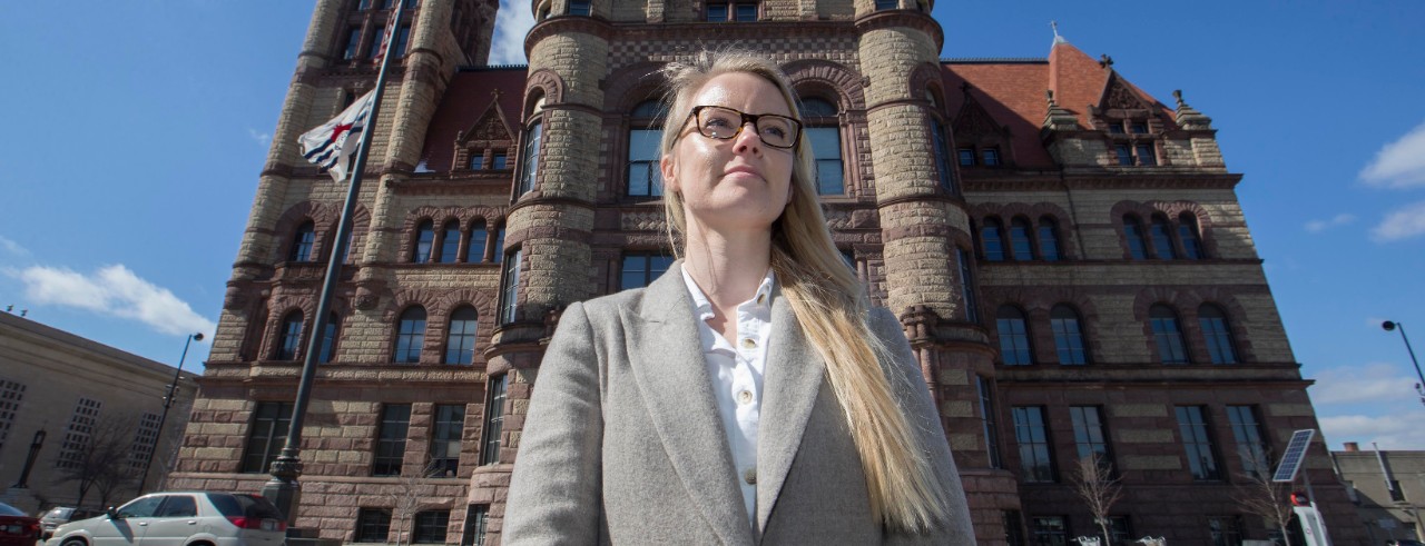 Elaina Johns-Wolfe stands outside Cincinnati City Hall.
