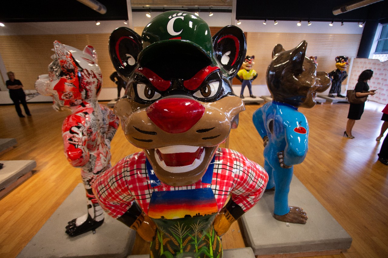 Frontal view of a statue of a Bearcat decorated as a farmer