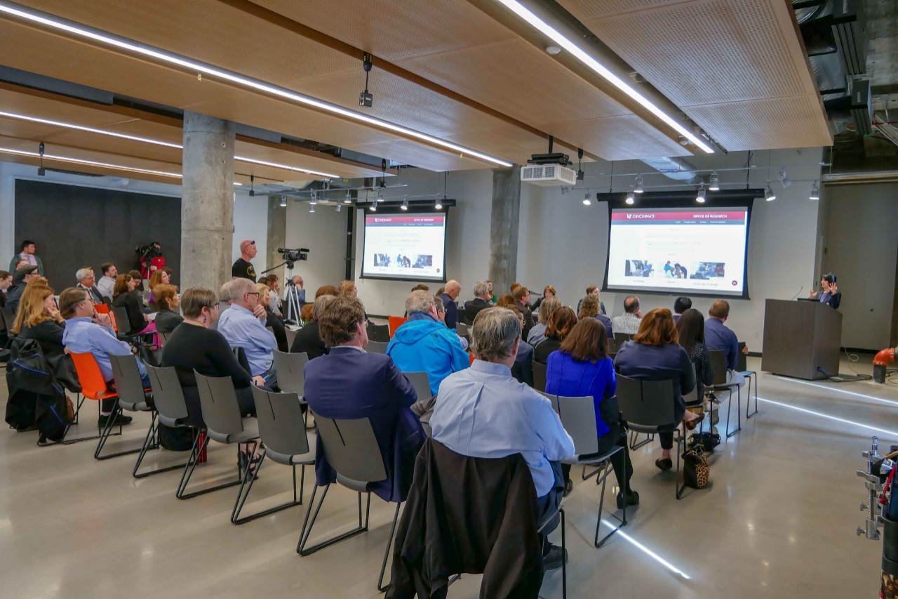 wide shot of room in innovation hub with panelists and attendees at event