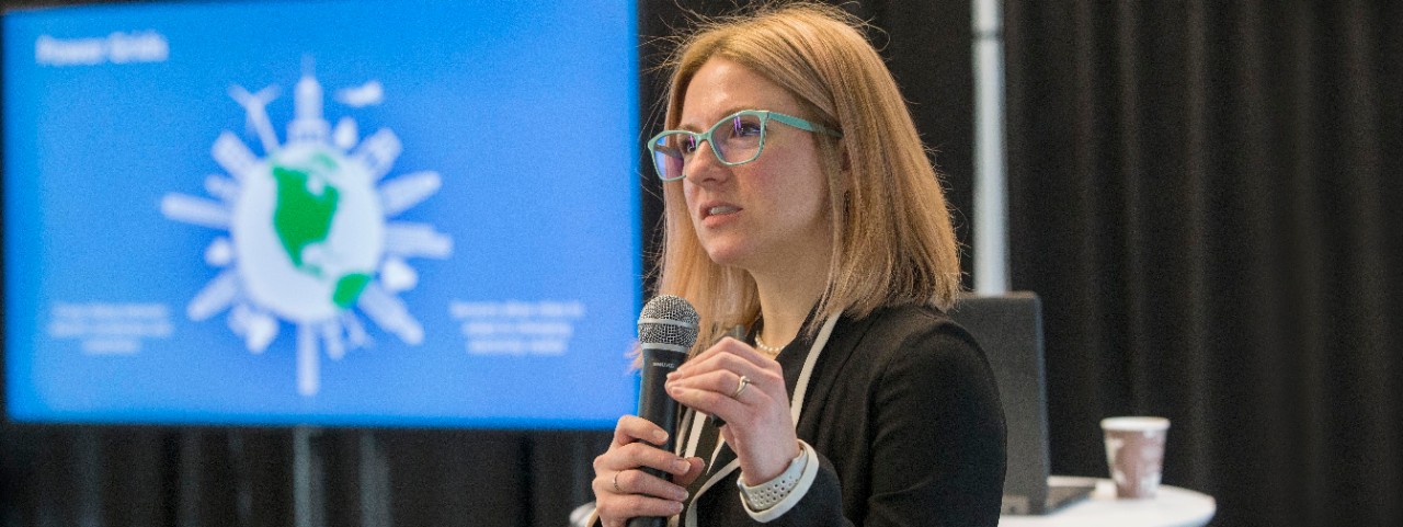 Elementary school children look inside a black autonomous vehicle at UC's Nippert Stadium