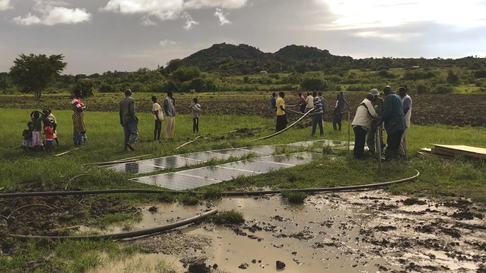 community members install solar panels
