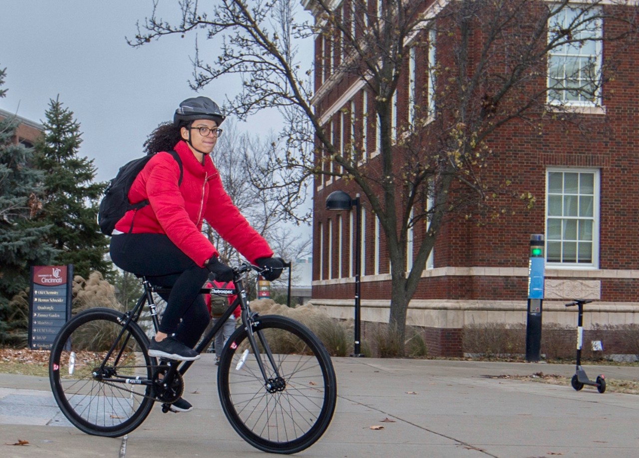 University Cincinnati student Sakina Jarmon rode her bike with UC McMicken in the background Thursday November 29, 2018. UC/Joseph Fuqua II 
