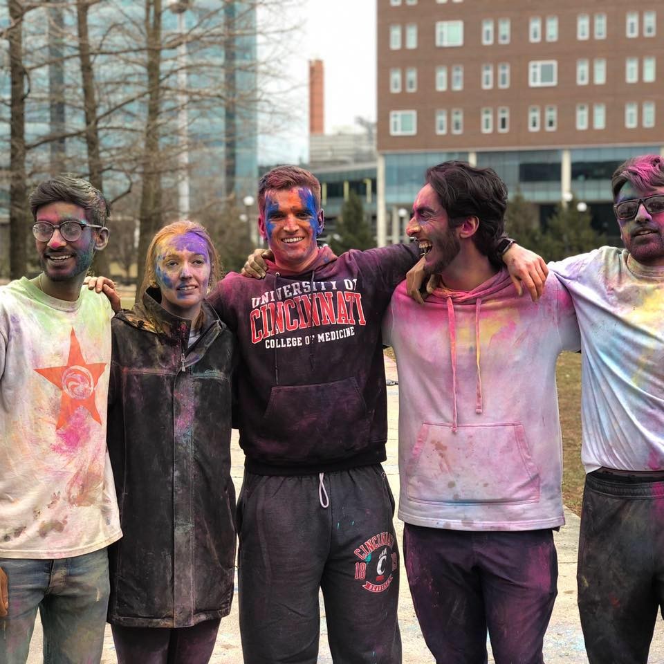 Scottie Emmert (center) is shown with friends at a UC event celebrating the Hindu festival Holi.