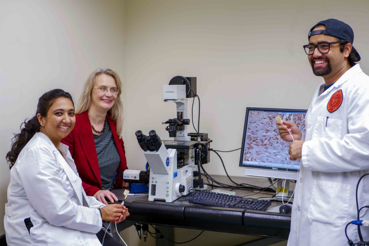 students and Narmoneva in lab