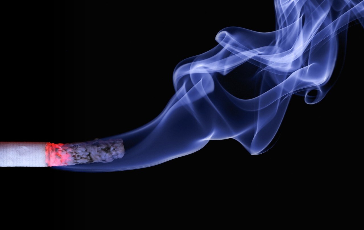 Wisps of smoke trail off of a cigarette