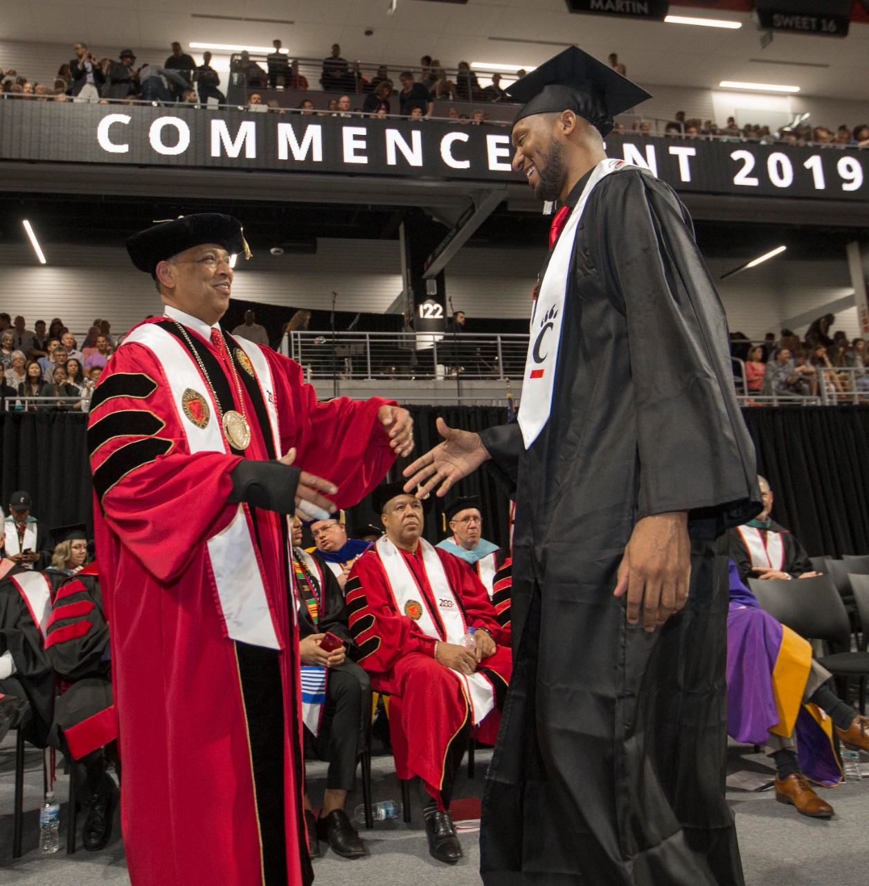 Former UC and NBA basketball player DerMarr Johnson, left shook University of Cincinnati president Neville G. Pinto hand. University of Cincinnati president Neville G. Pinto, faculty staff, students and families enjoyed the 2 p.m. Spring Commencement Ceremony at Nippert Stadium Friday May 3, 2019. UC/Joseph Fuqua II