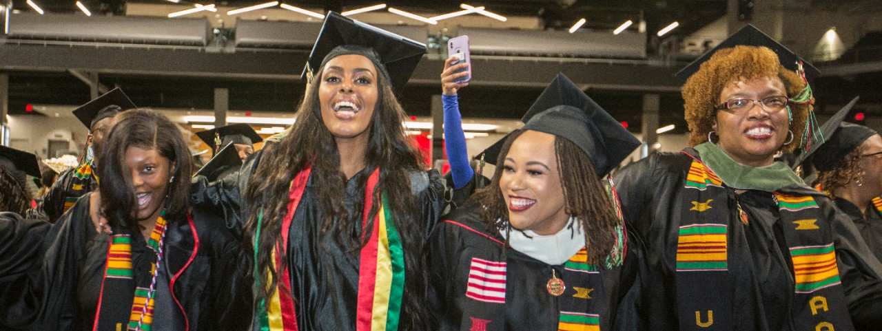 Four UC graduates laugh during Tyehimba.